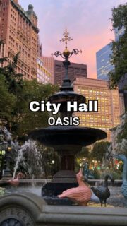 Need a little escape without leaving New York City? ⛲️✨The City Hall Park Fountain is one of those beautiful little oases that invites you to slow down and take it all in.The sound of the water, the surrounding greenery, and the incredible mix of architecture in every direction make this such a beautiful place to pause, especially at golden hour, when the changing light adds another layer to an already captivating setting. ✨Sometimes a quiet moment in the middle of it all is an NYC experience all its own.Did you know? The fountain dates back to 1871 and was actually moved to the Bronx in 1920. After decades away, it was restored and returned to its original home in City Hall Park in 1999. ⛲️Explore NYC with Just Ask Christine and discover what makes every corner of this city worth noticing. ❤️📍 City Hall Park | Lower Manhattan#CityHallPark #LowerManhattan #NYCHiddenGems #ExploreNYC #NYCArchitecture